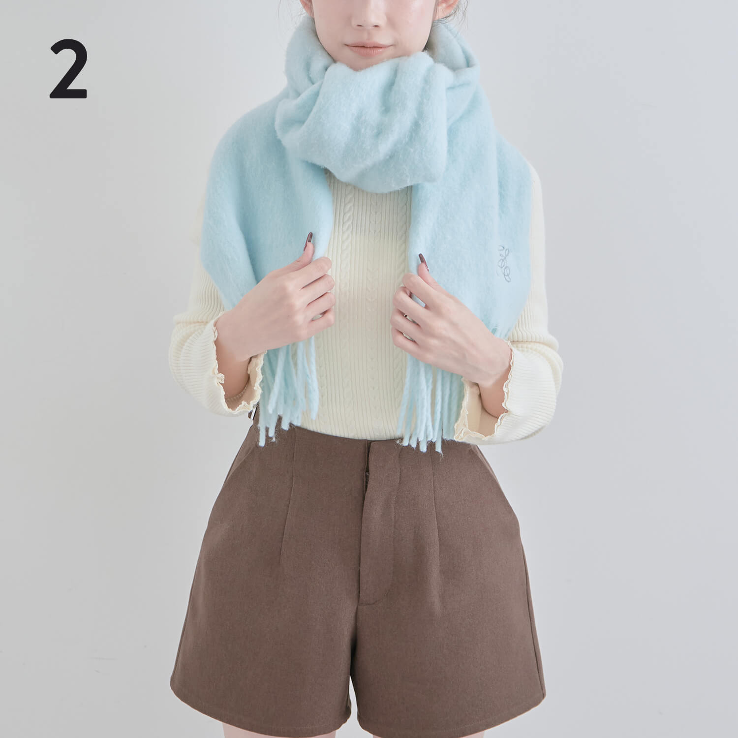 2）結び目をのどがあたる位置に持ってきて、そのままマフラーをぐるりと一周巻く|マフラー巻き方